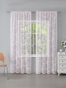Detail of light pink French lace curtain with elegant rose embroidery and scalloped edges