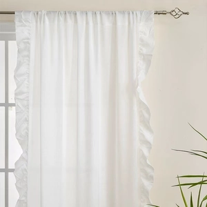 White semi-sheer velvet curtain with decorative ruffle edges on a metal rod for balcony