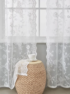 Close-up of elegant white lace curtain featuring delicate floral rose embroidery