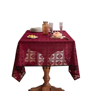 Elegant wine red lace tablecloth with geometric hollow patterns and black tassel edges