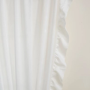 Detail of elegant white velvet curtain with ruffled edges and premium woven texture