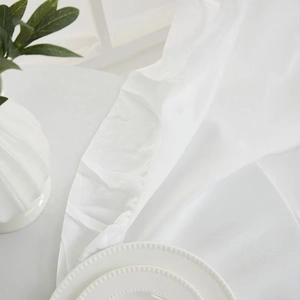 Macro shot of white velvet table runner with satin sheen and soft elegant fabric textures
