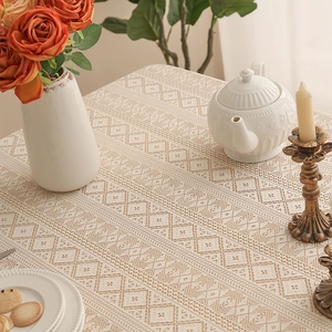 Close-up of bohemian hollow lace tablecloth with intricate geometric diamond crochet patterns