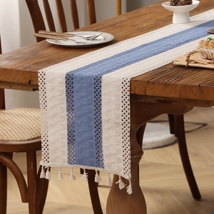 Knitted table runner with blue and beige stitching, hollow pattern, and fringe tassels