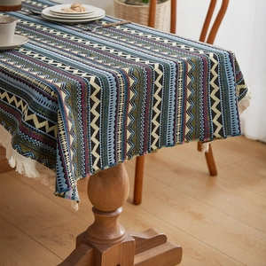 Bohemian geometric pattern tablecloth with tassels on a wooden dining table