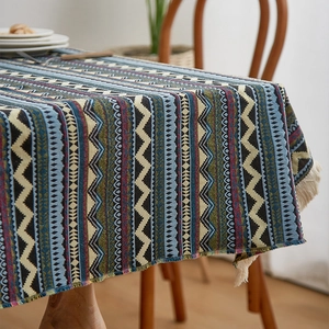 Detail of bohemian tablecloth featuring geometric patterns and soft cotton fringe edges
