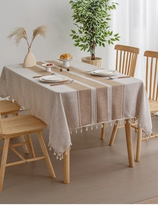 Detail of linen table cloth showing wave embroidery stripes and tassel fringe edges