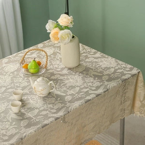 Elegant rectangular lace tablecloth featuring bird and floral embroidery with wavy edges