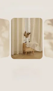 Detail of coarse linen door curtain with rustic texture and elegant white tassel trim