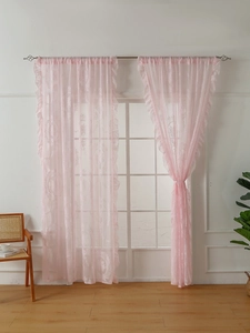 Detailed close-up of pink floral lace curtain with sheer texture and rod pocket design