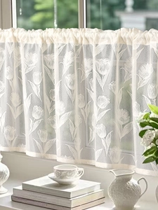 Detail of tulip pattern on lace cafe curtain showing textured semi-sheer fabric