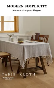 Detailed view of natural bamboo linen tablecloth texture featuring elegant cream fringe