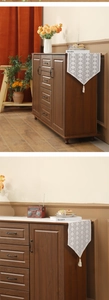 Close-up of vintage brown wood storage cabinet featuring retro metal handles and drawers