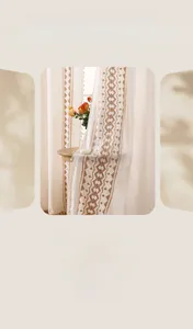 Detail of bohemian cotton linen curtain with geometric embroidery and tassel trim