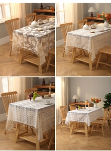 Close-up of bohemian ivory lace tablecloths with detailed embroidery and tassel edges