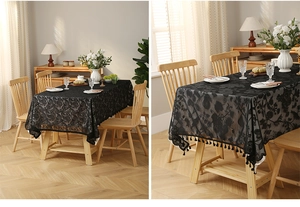 Detail of black lace tablecloth with floral hollow patterns and fringe tassels