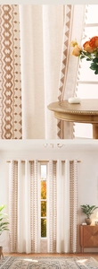 Detail of bohemian linen curtain with geometric embroidery and handmade tassel trim