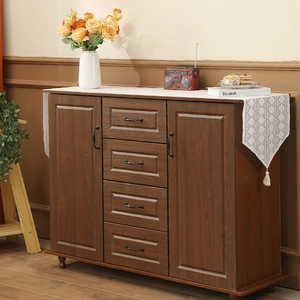 Retro brown wood sideboard cabinet with four drawers and two side doors in home setting