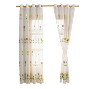 Elegant sheer white curtains featuring tulip floral embroidery and silver metal grommets