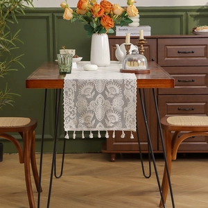 Vintage white lace table runner with hollow crochet floral patterns and fringe tassels