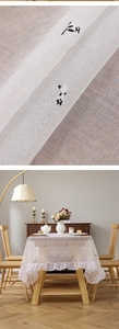 Detailed embroidery of panda on sheer white tablecloth with elegant ruffled edges