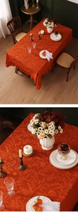 Macro detail of retro orange lace tablecloth with floral jacquard and ruffled edges