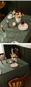 Detail of dark green floral lace tablecloth with elegant ruffled edges and retro style