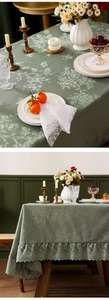 Detail of vintage green floral jacquard tablecloth with ruffle lace edge and pleated trim