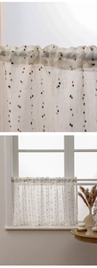 Detail of sheer cafe curtain with colorful pom-poms and rustic linen-like texture
