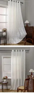 Close-up of white lace curtain with vertical stripe pattern and black metal grommets