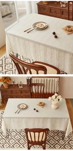 Close-up of striped linen tablecloth featuring textured weaving and elegant white tassels