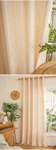 Detailed macro view of cream lace hollow-out floral pattern fabric for window curtains