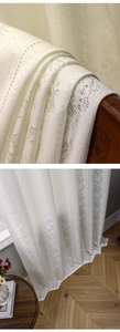Detailed view of white floral lace curtain with vertical textured jacquard pattern