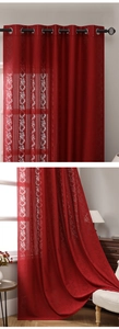 Detail of red Bohemian lace curtains with floral patterns and metal rings for roman rods