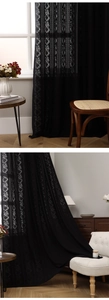Detailed view of black floral lace curtain with semi-transparent vertical embroidery