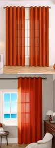 Detail of orange grommet sheer curtains featuring vertical stripe mesh texture for living room