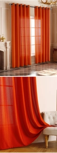 Detailed texture of orange vertical stripe semi-sheer grommet curtains in living room