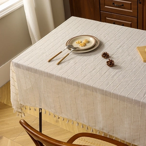 Minimalist beige striped linen tablecloth with decorative tassel trim for wooden tables