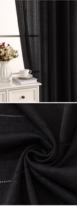 Detailed close-up of black vertical striped sheer curtain fabric with semi-transparent mesh