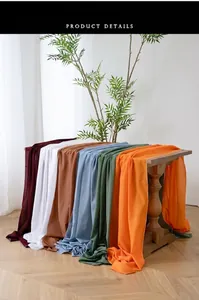 Detail of vibrant chiffon table runners with elegant drape on a vintage wooden table