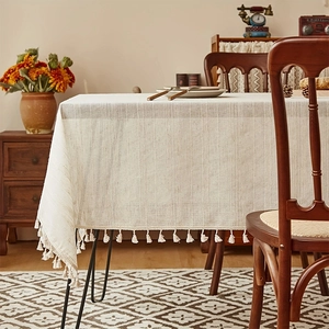 Japanese style striped linen tablecloth with decorative fringe on a wooden table