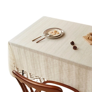 Linen striped tablecloth with elegant tassel edges on a minimalist dining table