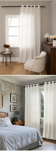Detailed view of white vertical striped semi-sheer curtains with black metal grommets