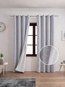 Detail view of American floral blackout curtains with fine fabric texture and silver grommets