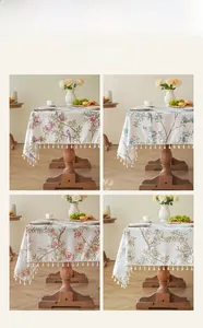 Close-up of bird and floral print linen tablecloths with elegant white tassel fringe
