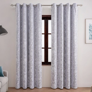 Detailed view of grey floral blackout curtains with elegant white patterns and metal grommets