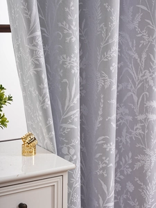 Detail of light gray blackout curtain with elegant leaf jacquard pattern texture