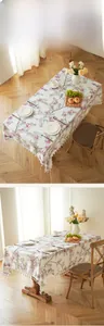 Detail of bird floral linen tablecloth with decorative beige tassels and fringe trim