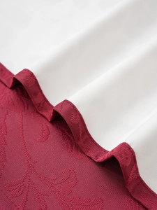 Detail of burgundy floral jacquard fabric with premium lace coating and stitching