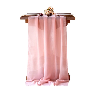 Elegant pink chiffon table runner on wooden table for wedding or party table decoration